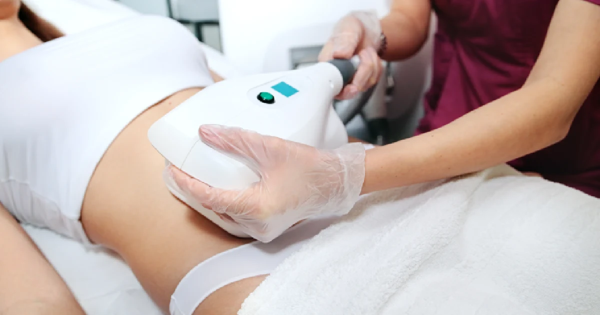 A woman receiving a CoolSculpting treatment in Seattle, WA